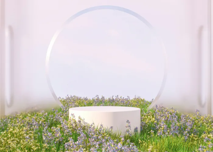 White pedestal surrounded by purple wildflowers with glass circle backdrop