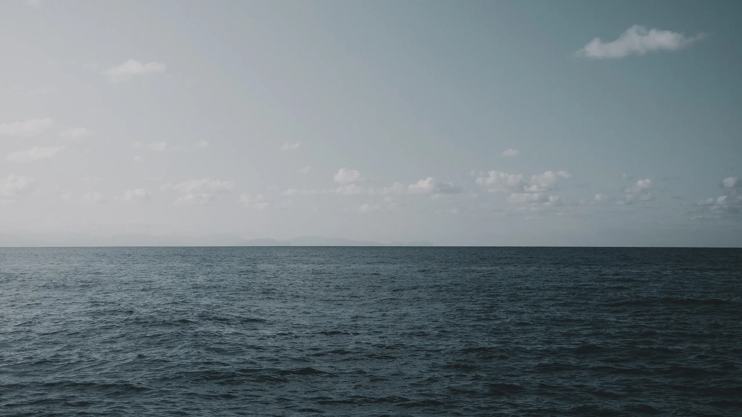 Abstract digital landscape made of glowing white dots forming a grid on a dark background.