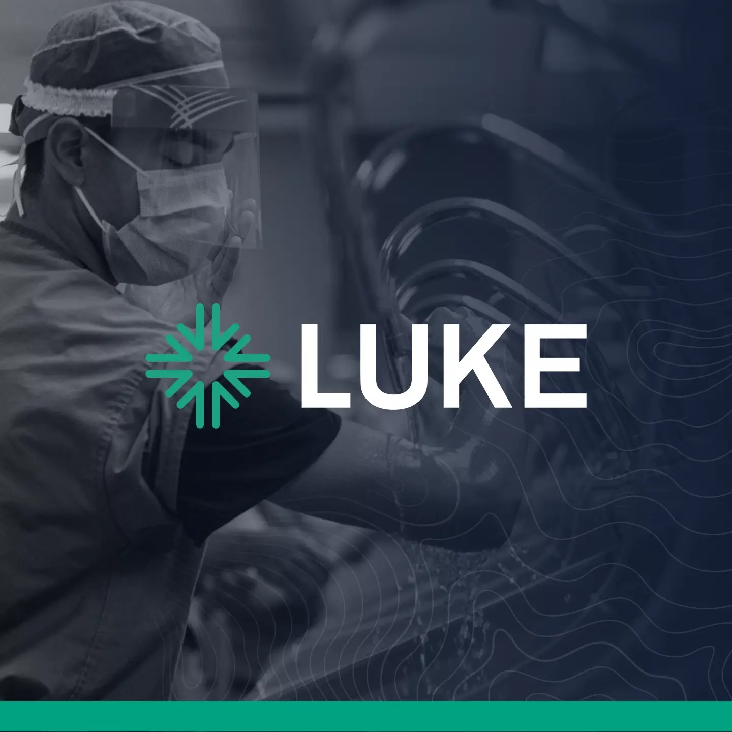 Healthcare worker wearing protective mask and face shield washing hands at multiple sinks.