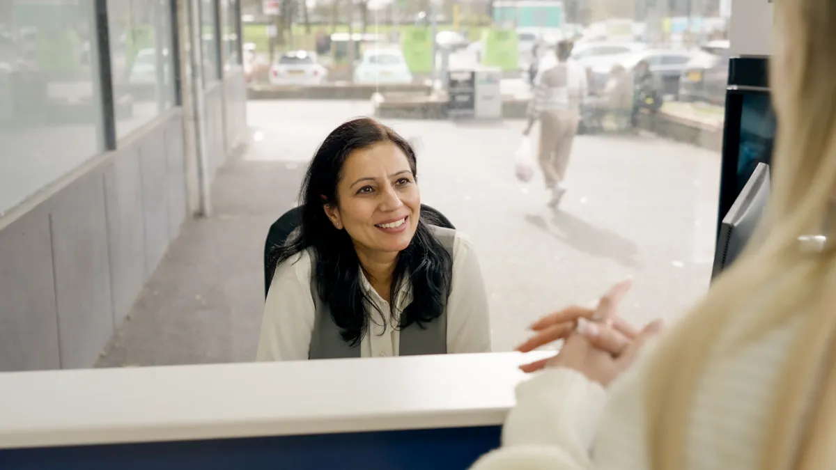 Friendly opticians receptionist welcoming customer at Collisons Opticians practice