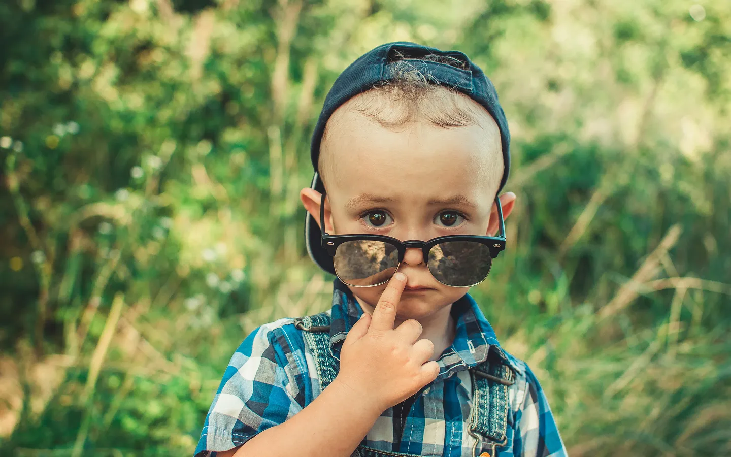 Young child wearing UV protection sunglasses - children's eye health and sun safety
