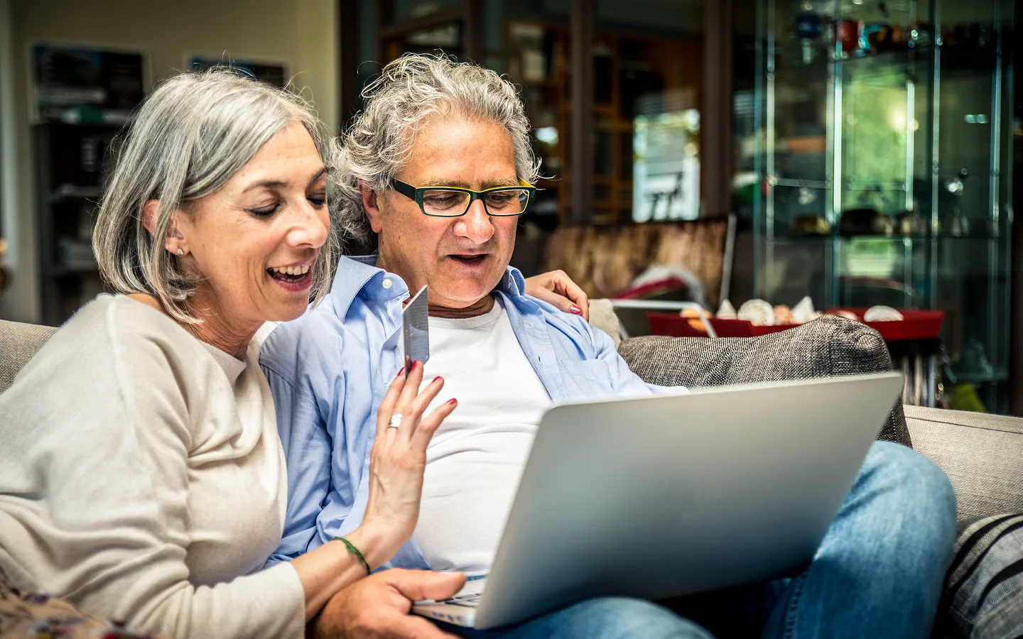 Middle-aged couple researching hearing test options and hearing aid services online together"