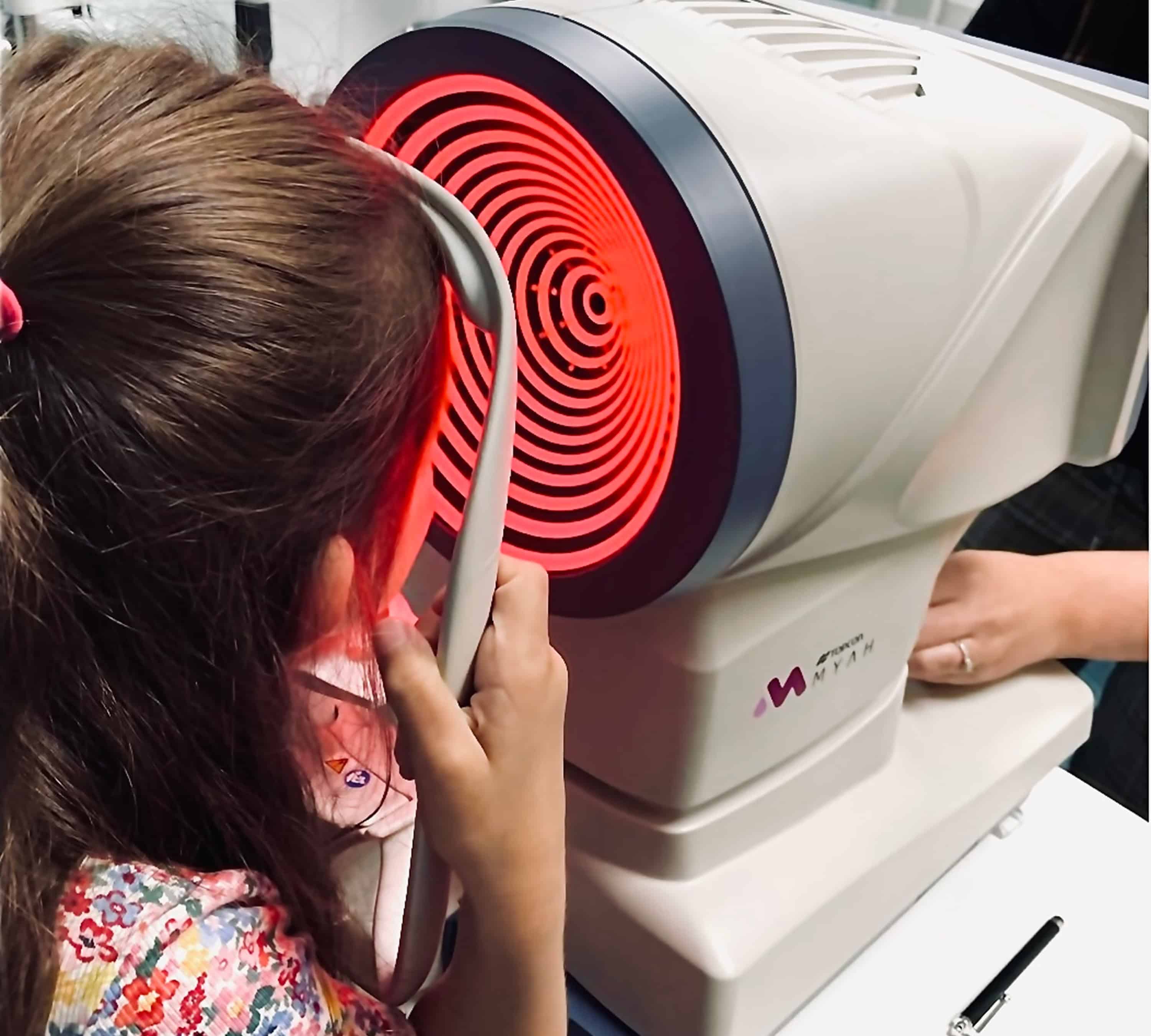 Child receiving myopia control treatment using advanced eye care technology for vision management