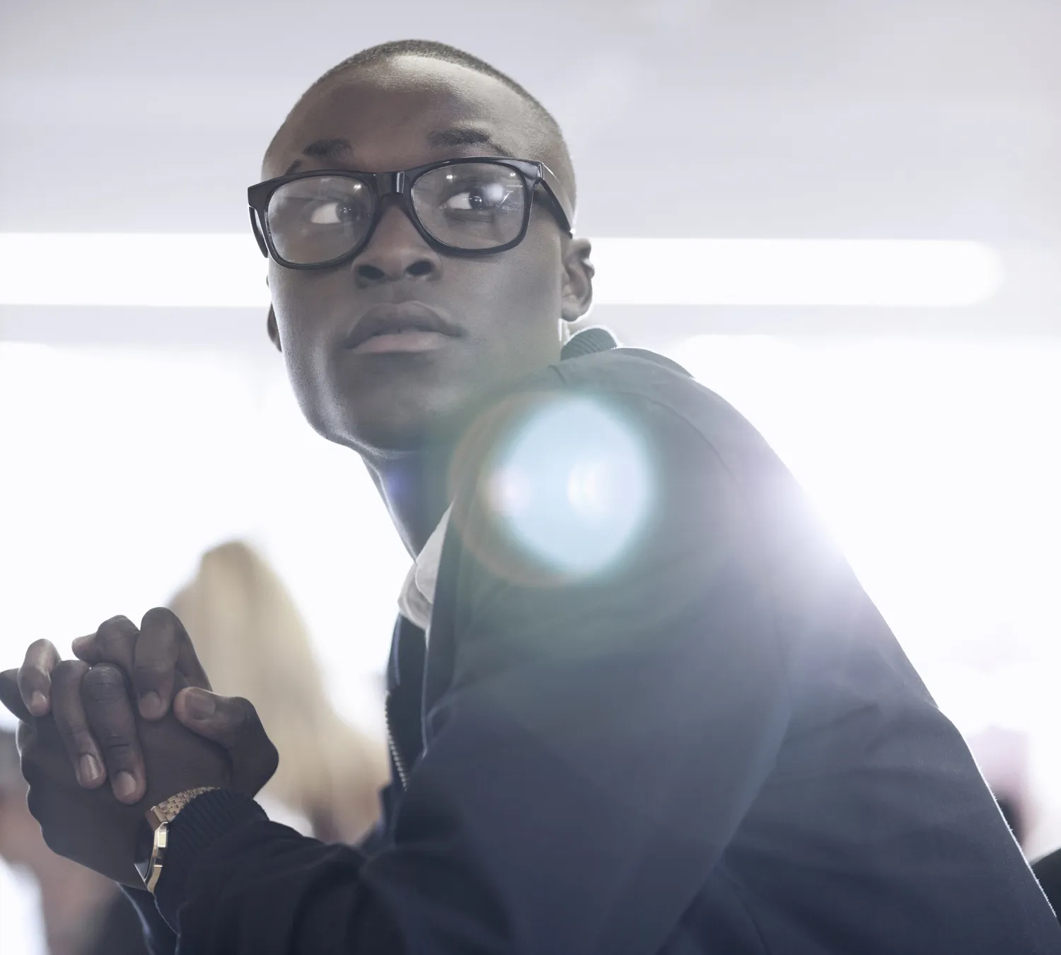 Man wearing stylish black prescription glasses frames available at opticians