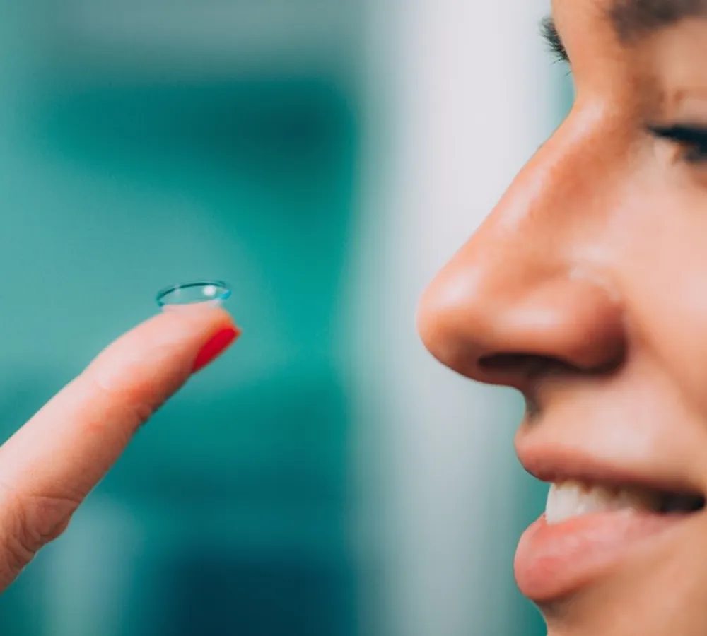 Soft contact lens on fingertip before insertion for vision correction