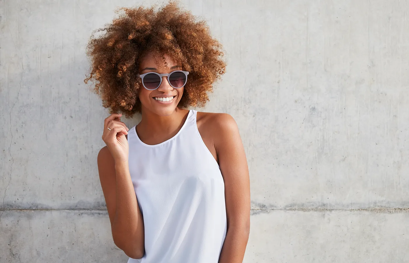 Woman wearing stylish designer sunglasses with UV protection from opticians