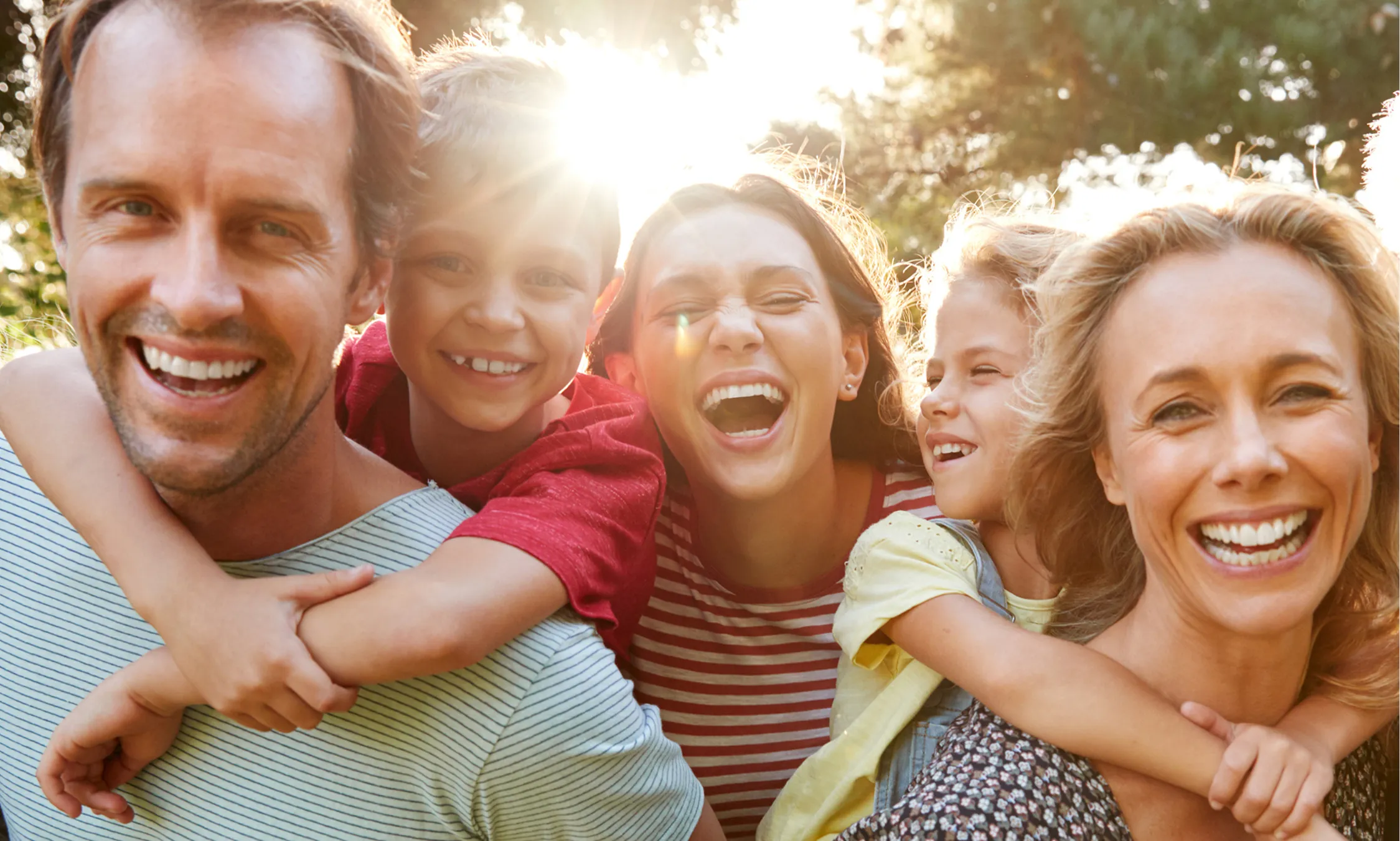 Multi-generational family enjoying clear communication with professional hearing care services and hearing aids