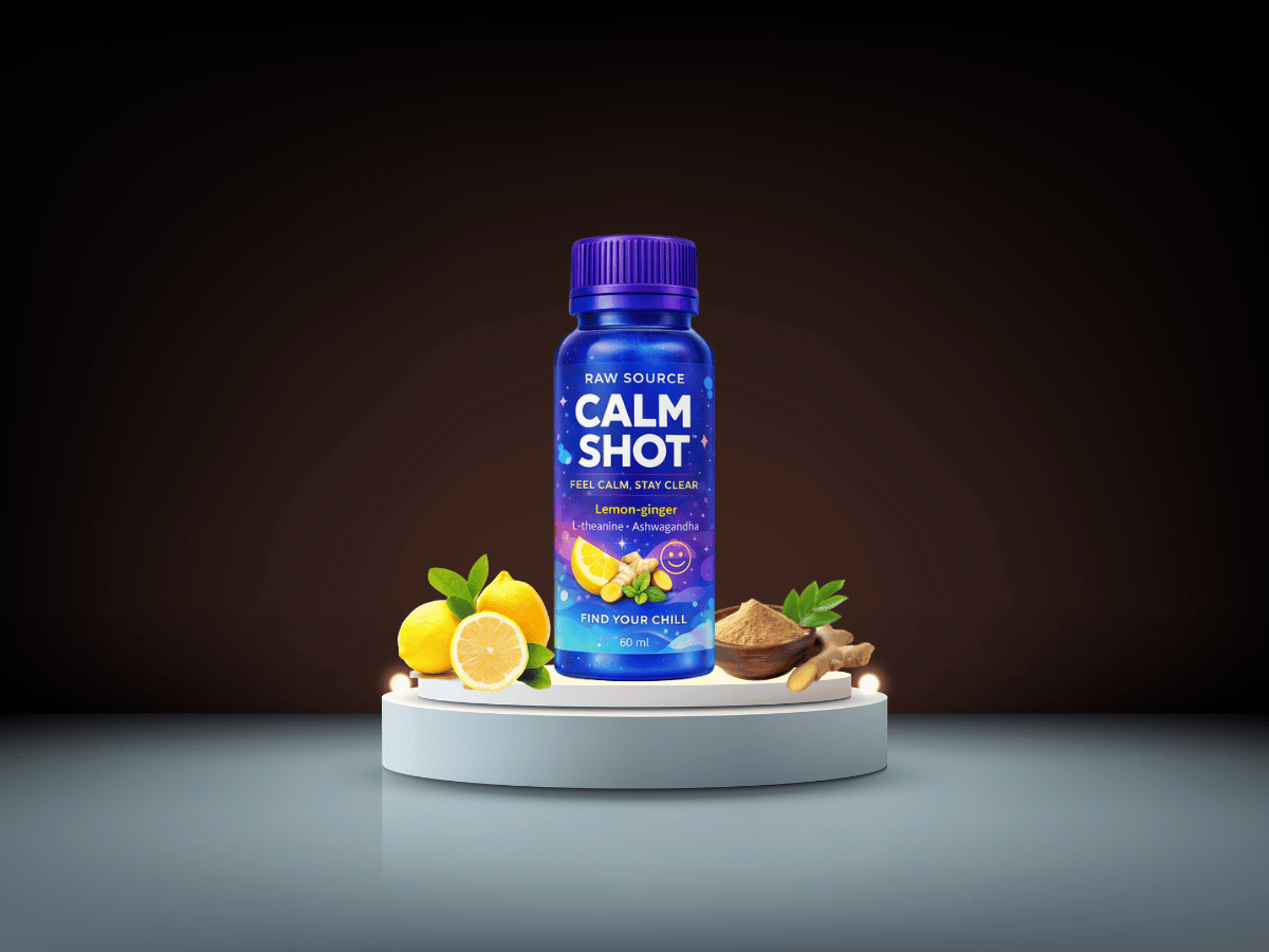 Wellness shot bottle displayed with lemon and ginger on a clean surface