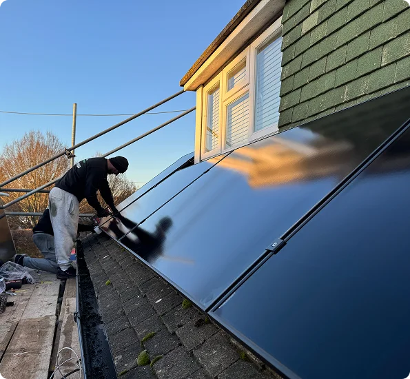 an engineer installing solar panels on a roof