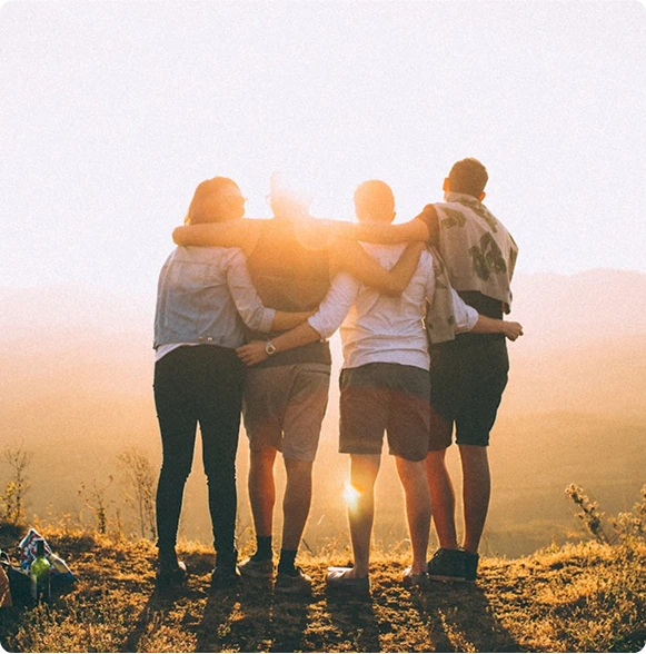 A group of friends standing and watching the sun set