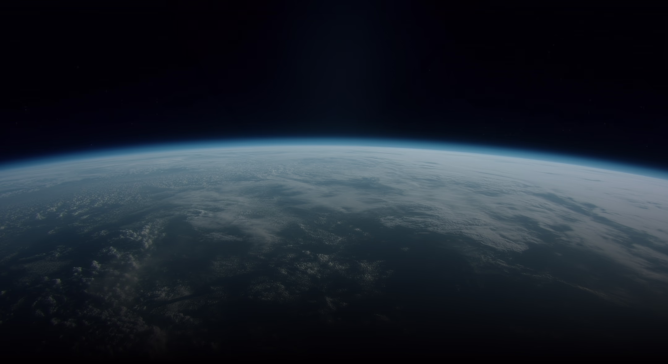 Curved horizon of Earth with scattered clouds against the blackness of space.
