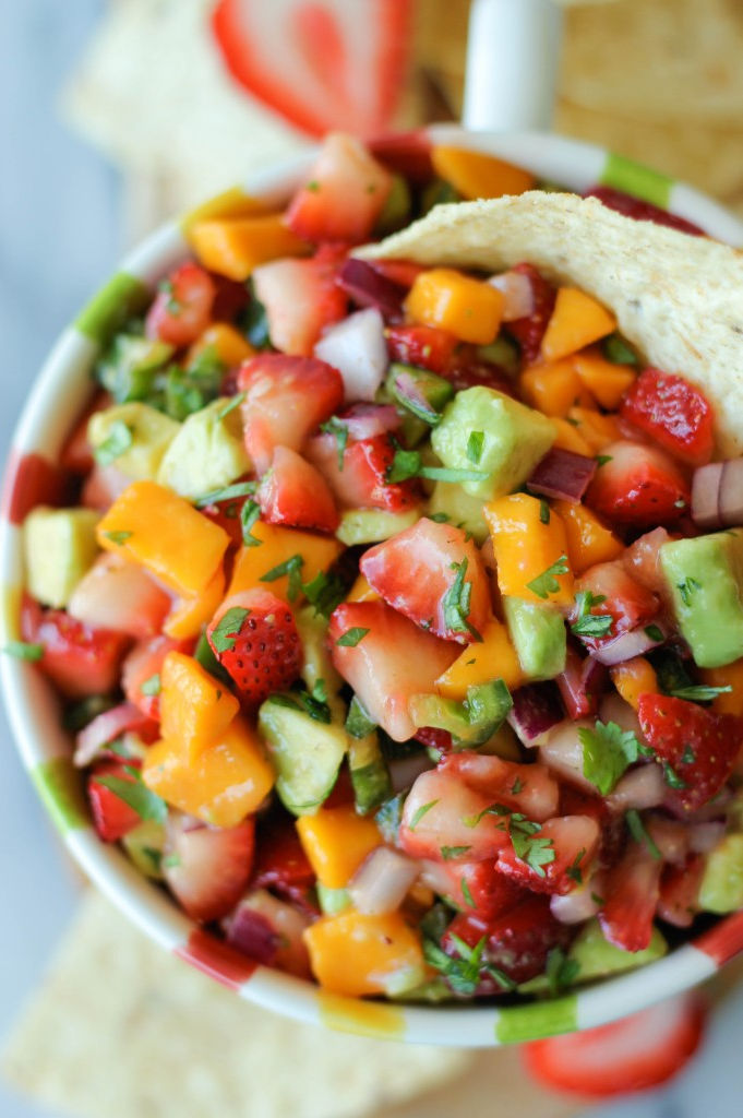 Strawberry and avocado pico de gallo with colorful diced peppers and cilantro, served with tortilla chips.