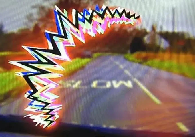 Blurred road scene with colorful zigzag graphic overlay creating a distortion effect.
