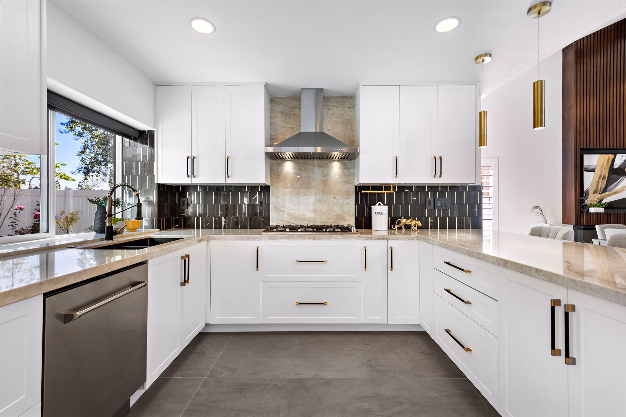 Bayside Residence kitchen with clean cabinetry, generous prep space, warm metal details, and open layout.
