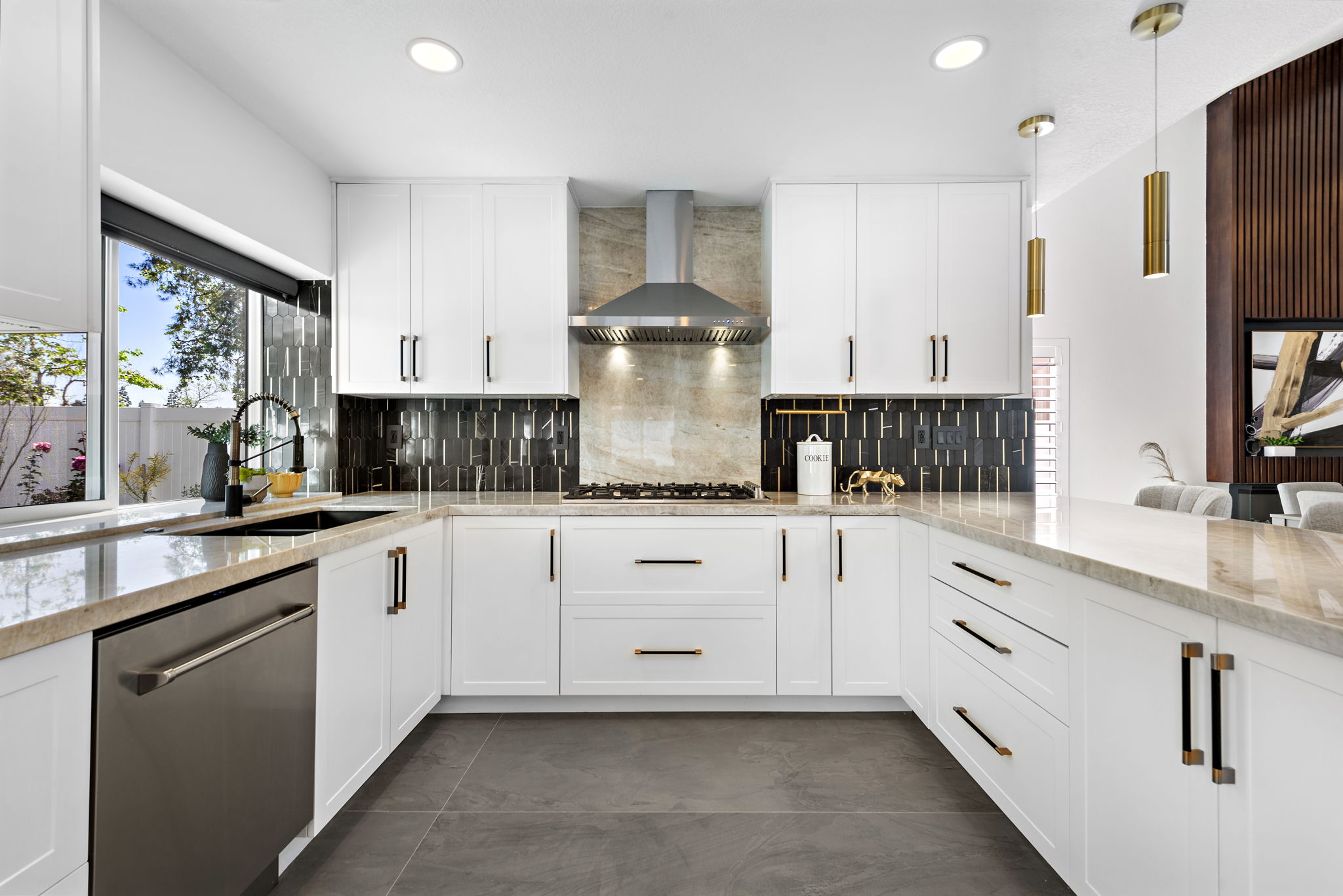 Bayside Residence kitchen with clean cabinetry, generous prep space, warm metal details, and open layout.