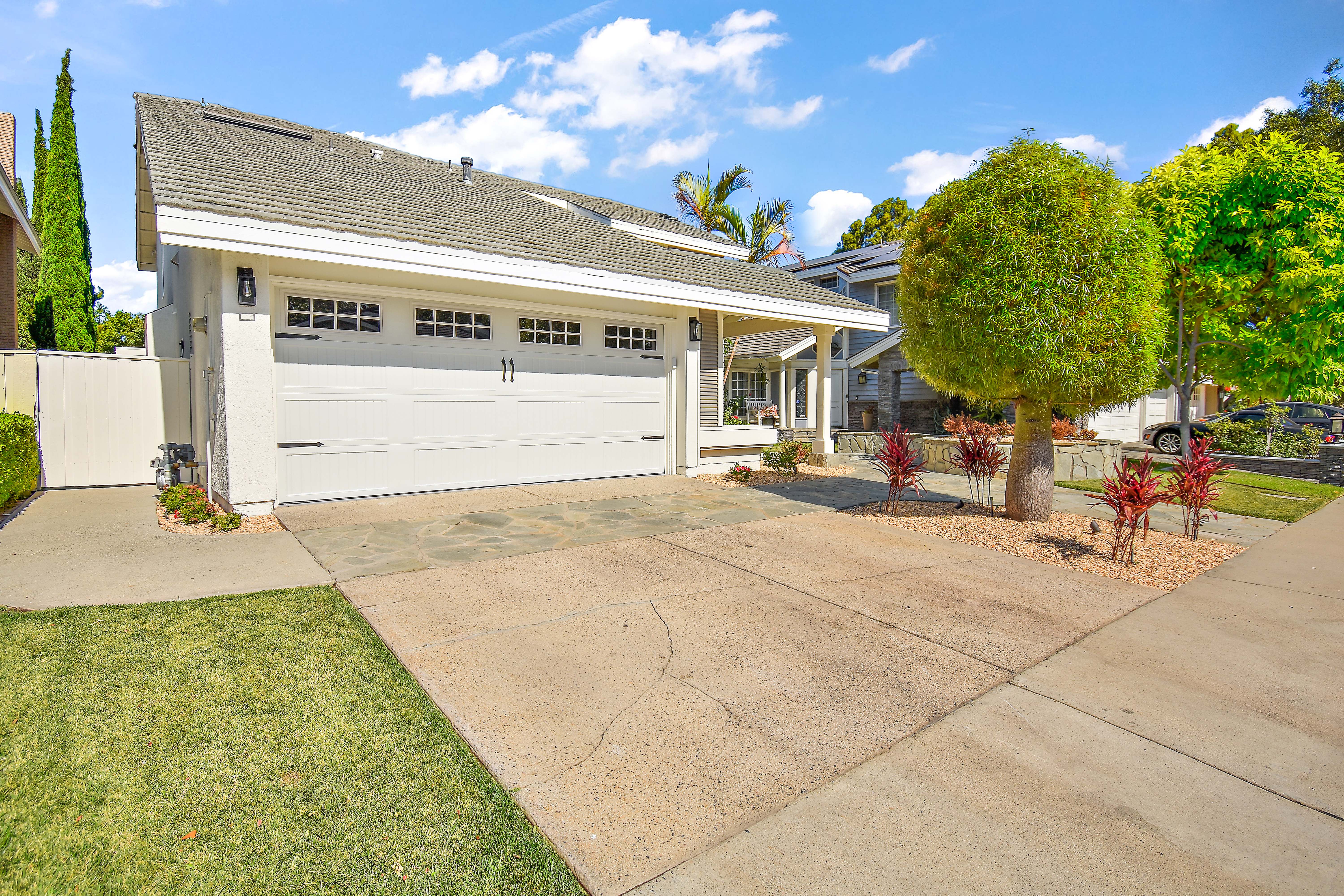 Rainstar Residence exterior in Irvine with bright renovated architecture and a private landscaped yard.