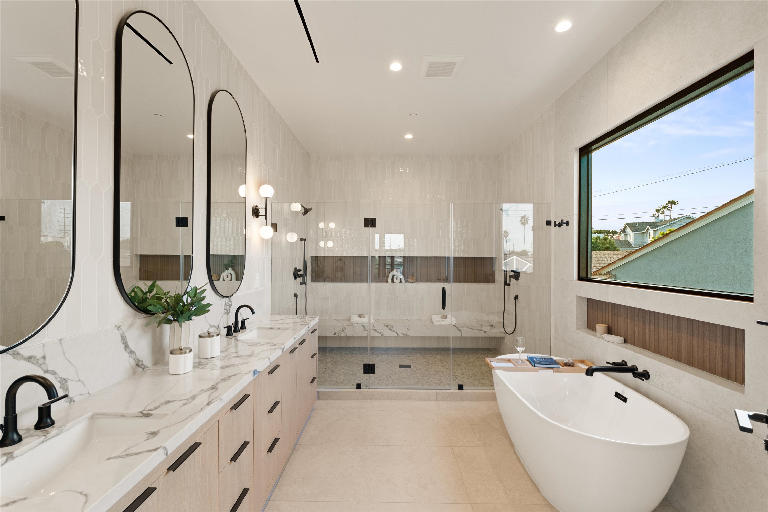 Spa-like Cluster Residence bathroom with freestanding tub, glass shower, and bright modern finishes.