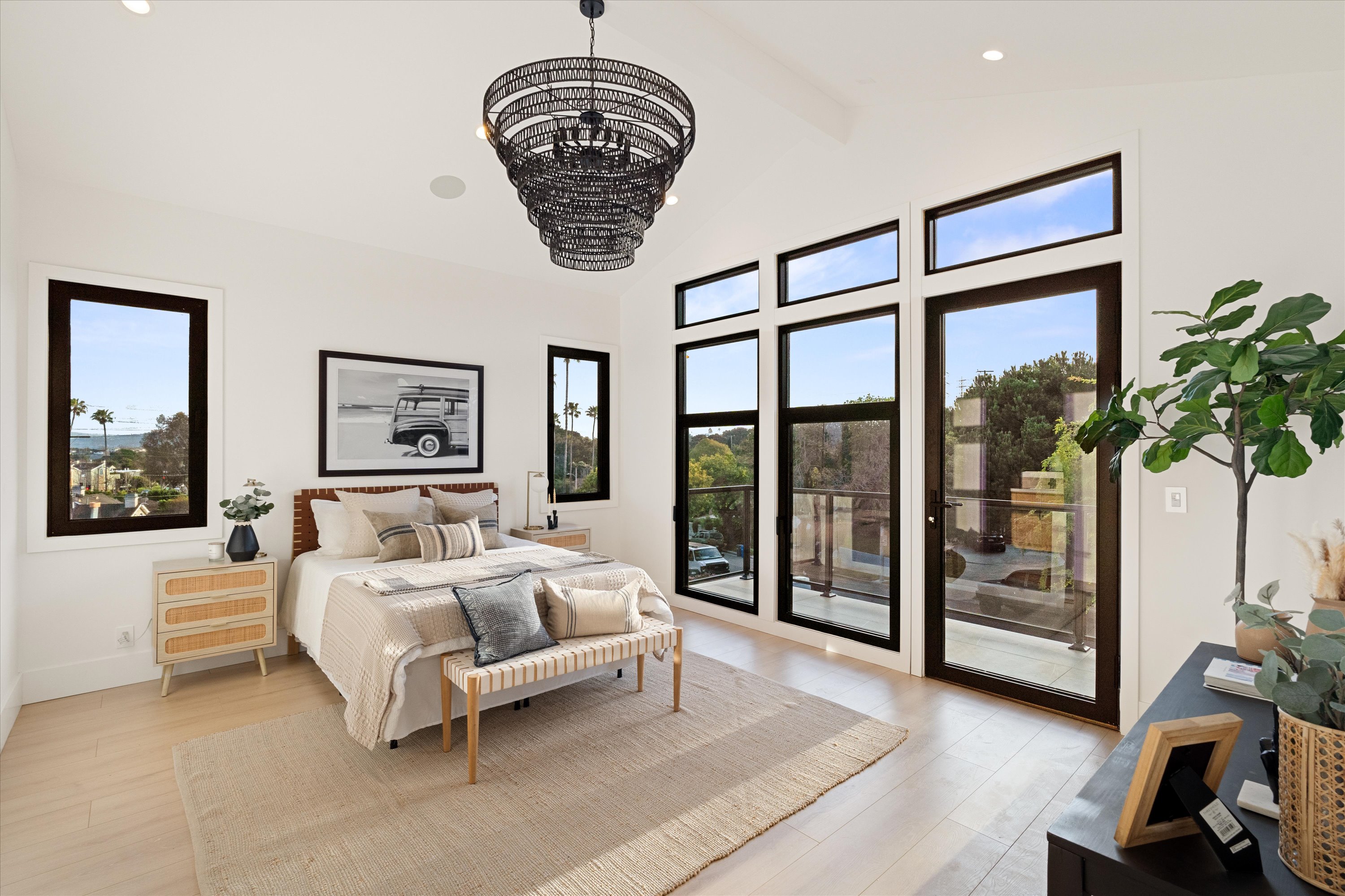 Light-filled Cluster Residence bedroom with large windows, neutral furnishings, and balcony access.