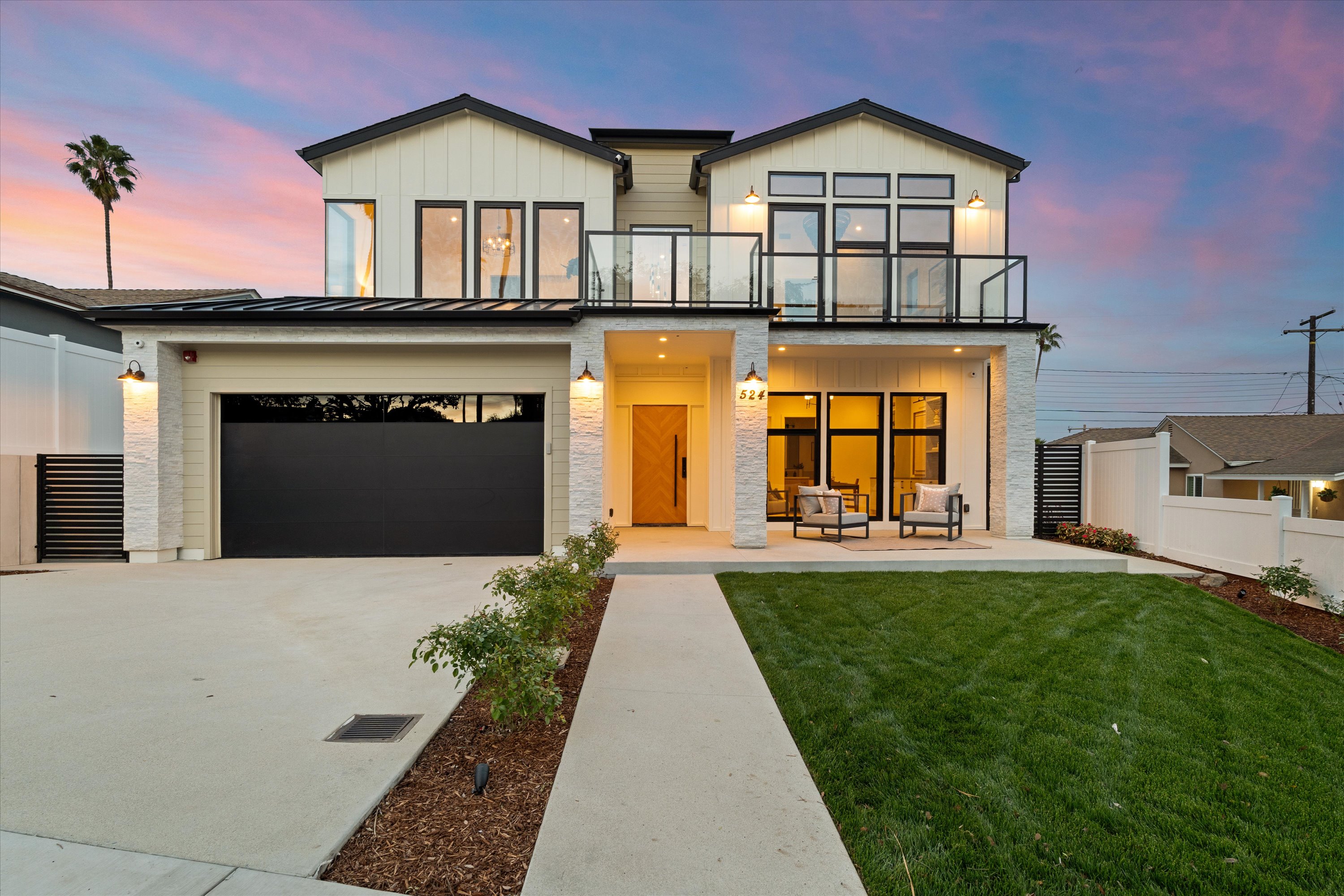 Exterior of Cluster Residence, a modern white two-story home with large windows and a landscaped entry in Redondo Beach.