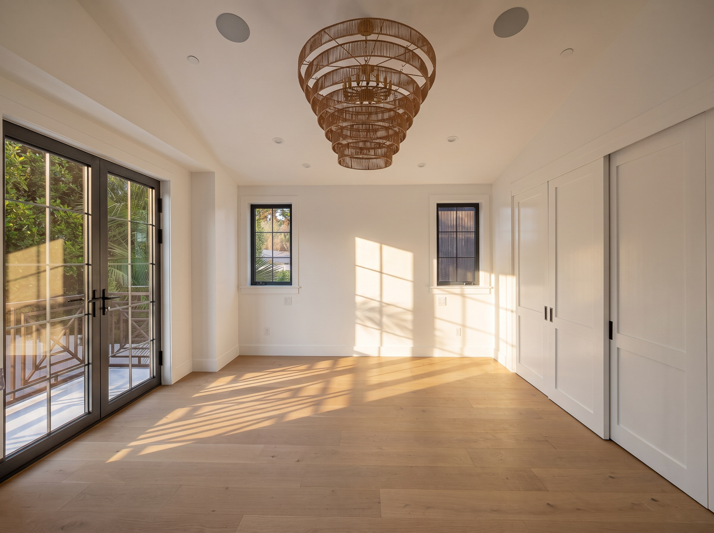 Pine Residence bedroom with vaulted ceiling and balcony doors