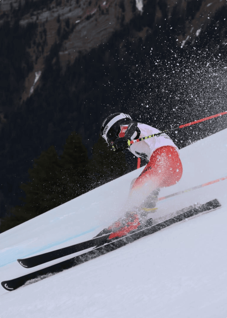 A person on skies going down a slope