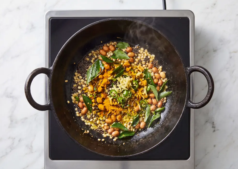 curry leaves, grated ginger, green chillies, and turmeric powder