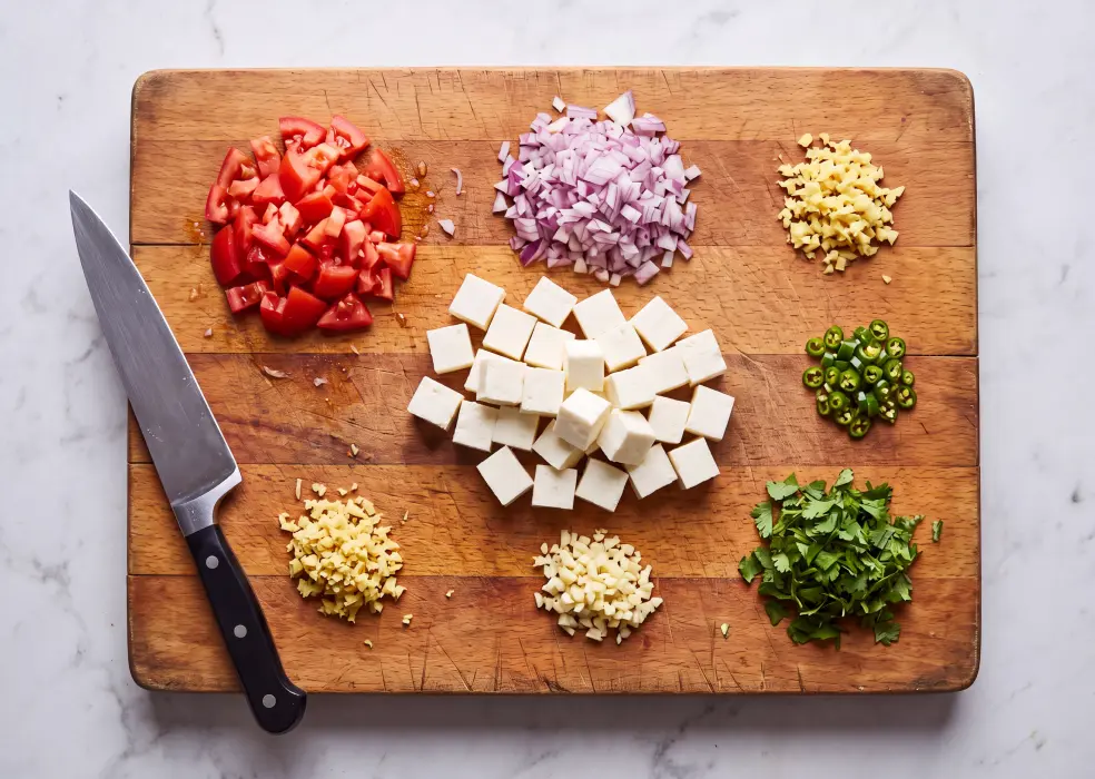 Paneer, Tomatoes, onion, ginger, and garlic, green chillies and coriander leaves.