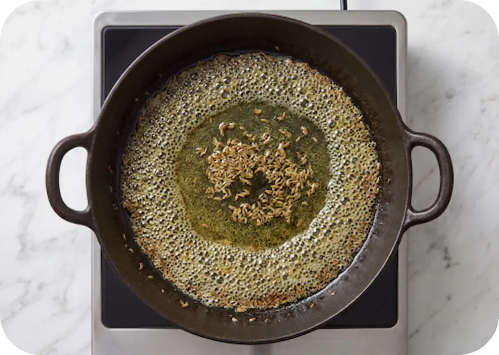 Heat the ghee in a kadhai and cumin seeds