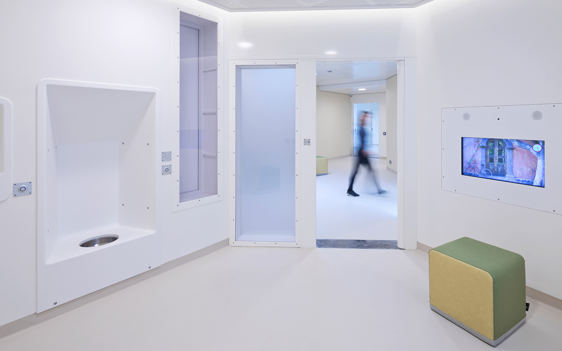 iSmart human-centered identification and safety solution digital kiosk displayed in a modern, wood-paneled office environment with a professional walking by.