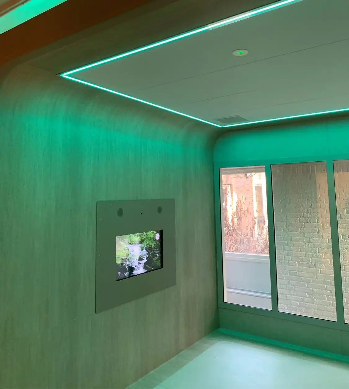 iSmart human-centered identification and safety solution digital kiosk displayed in a modern, wood-paneled office environment with a professional walking by.