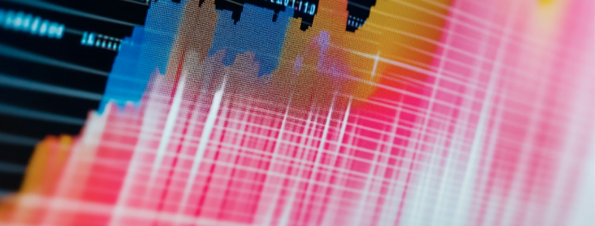 Close-up of computer circuit board with colorful blue, pink, and orange light patterns showing digital data processing