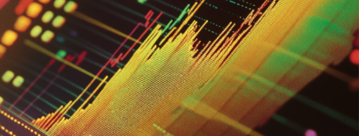 Close-up of computer circuit board with colorful blue, pink, and orange light patterns showing digital data processing