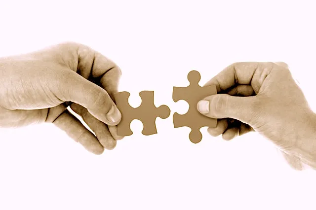 chatbot trends 2018 two hands joining two puzzle pieces together.