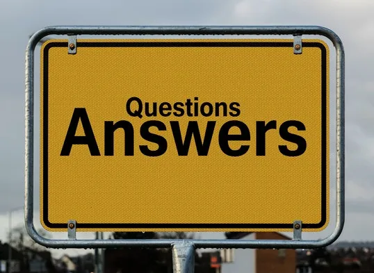A yellow road sign that says "Questions" "Answers" in black letters.