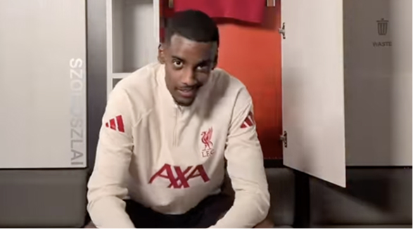 Alexander Isak in the Liverpool jersey siting in the dressing room