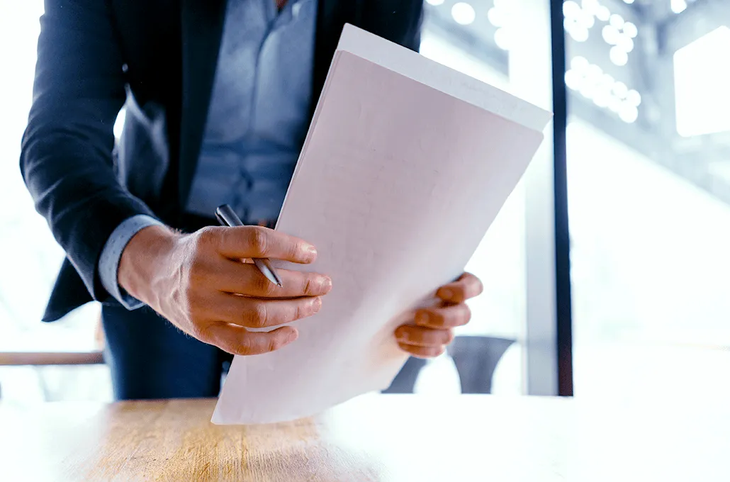 Person holding white papers
