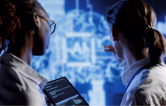 Two medical professionals analyzing complex AI data and neural networks on a large digital display.