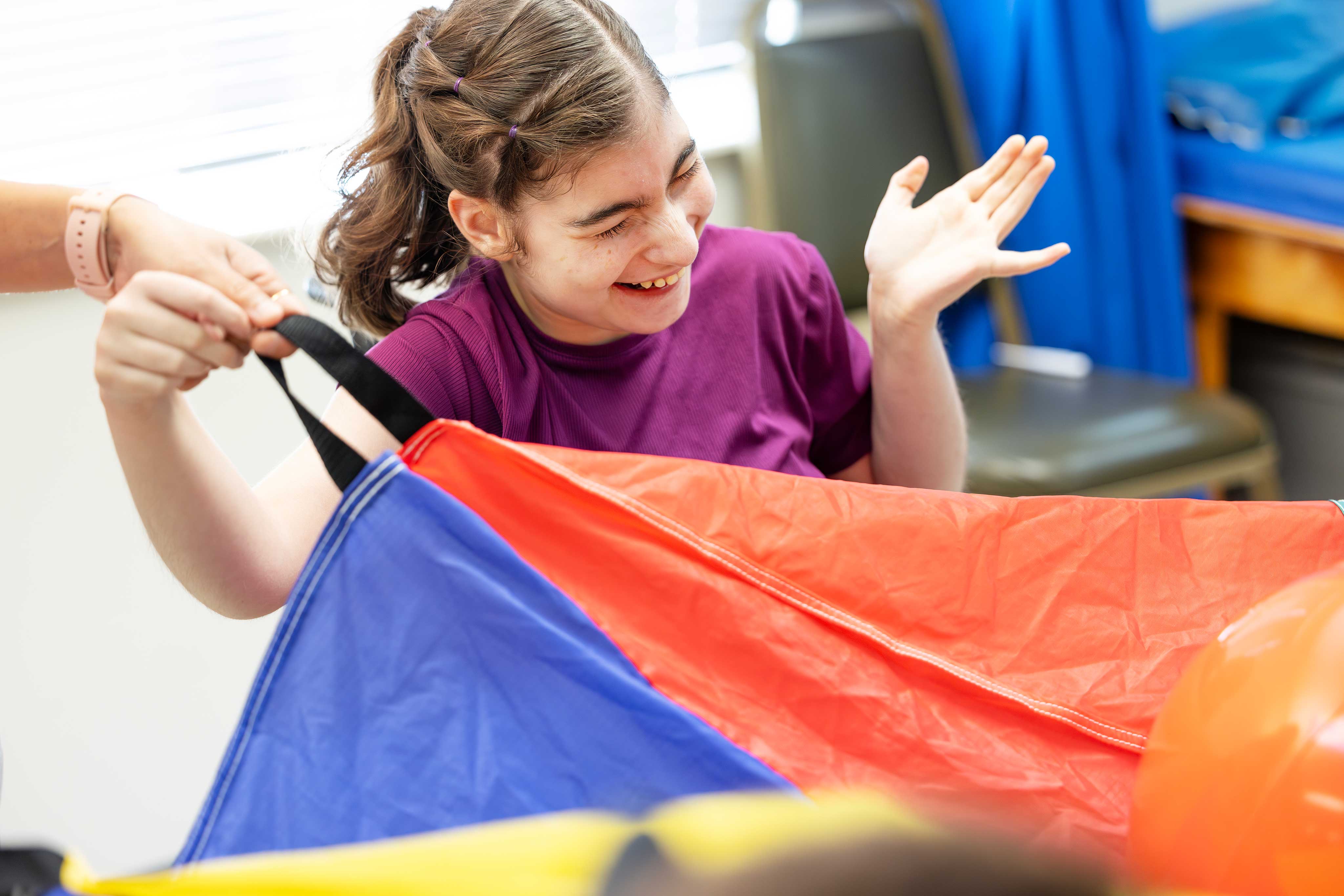 a young girl is playing with a kite