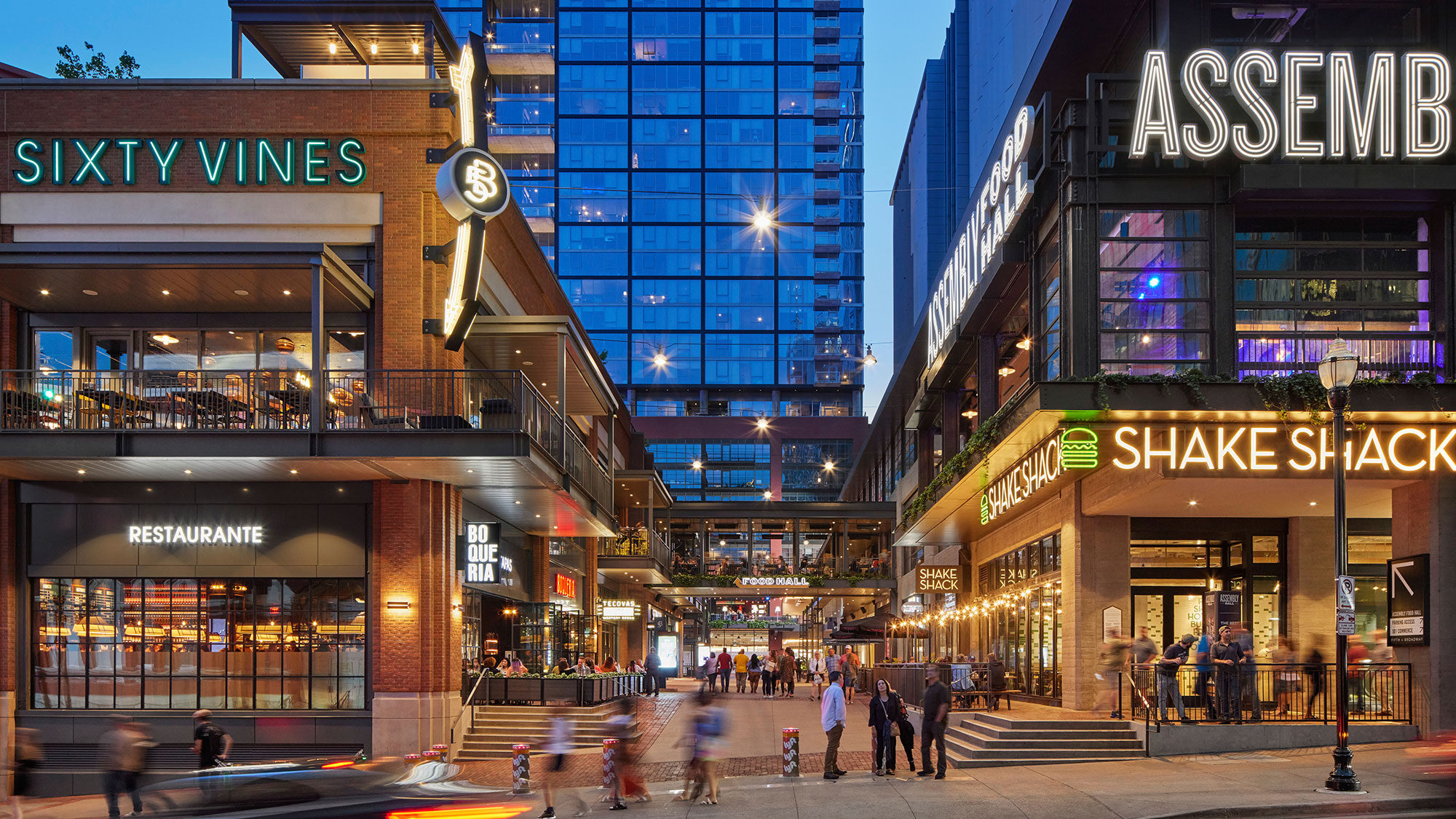 A street with people walking on it and buildings around it.