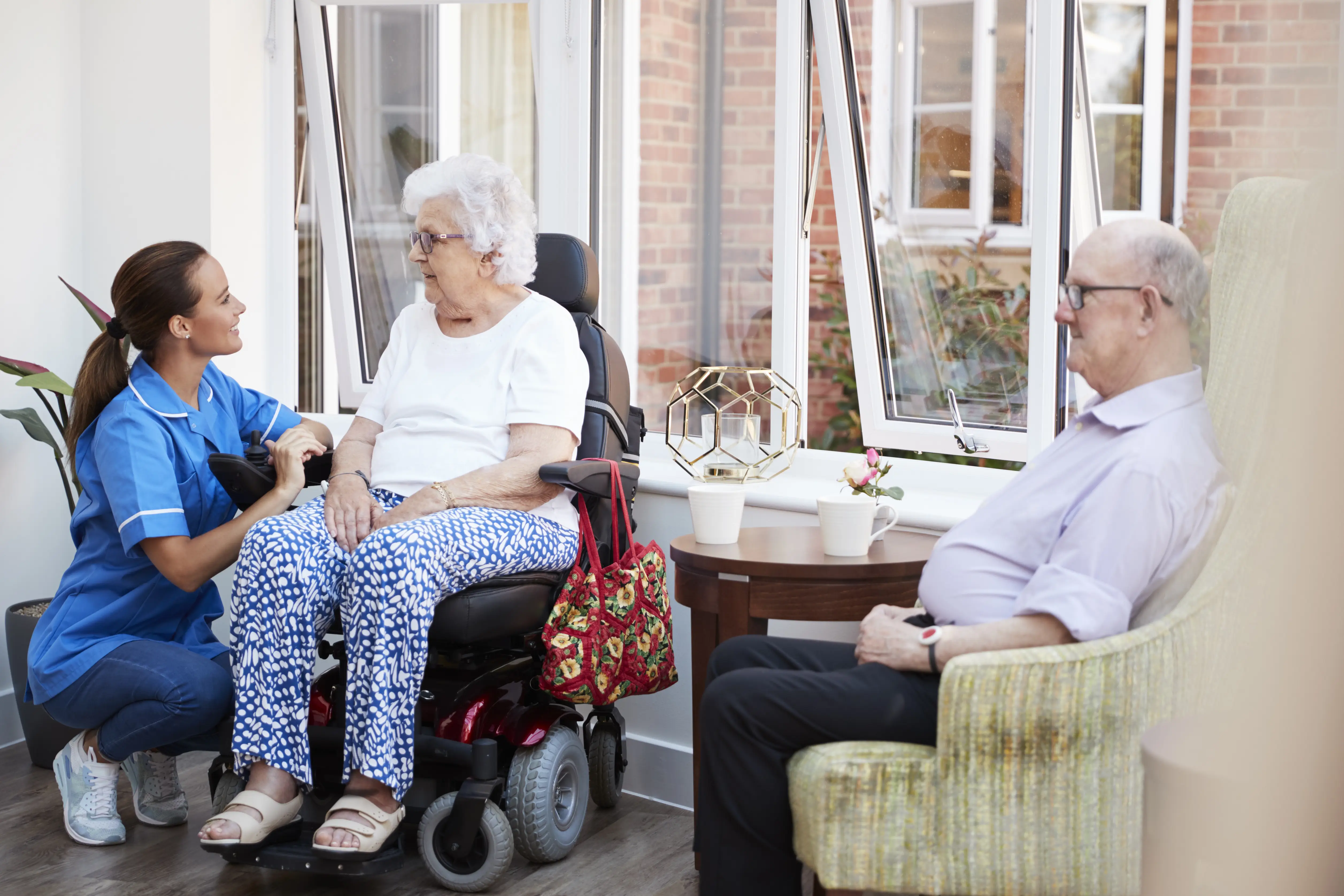 Carer supporting male and female residents 