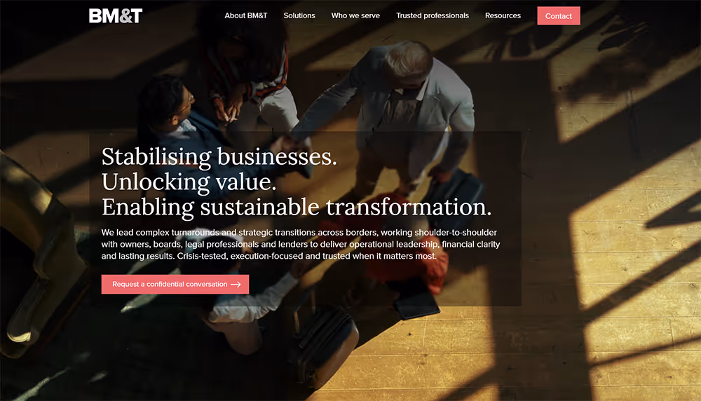 Overhead view of business professionals shaking hands in a sunlit room with text about stabilising businesses and enabling sustainable transformation.