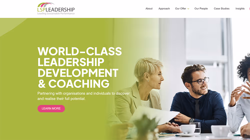 Business professionals in a meeting with text highlighting world-class leadership development and coaching services.