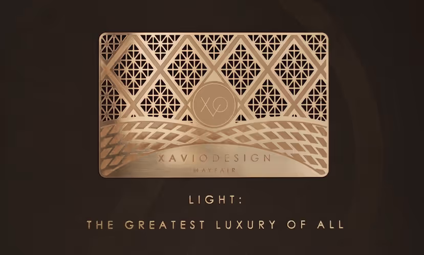 Elegant gold geometric design with the text 'Xavio Design Mayfair' and phrase 'Light: The Greatest Luxury of All' on a dark background.