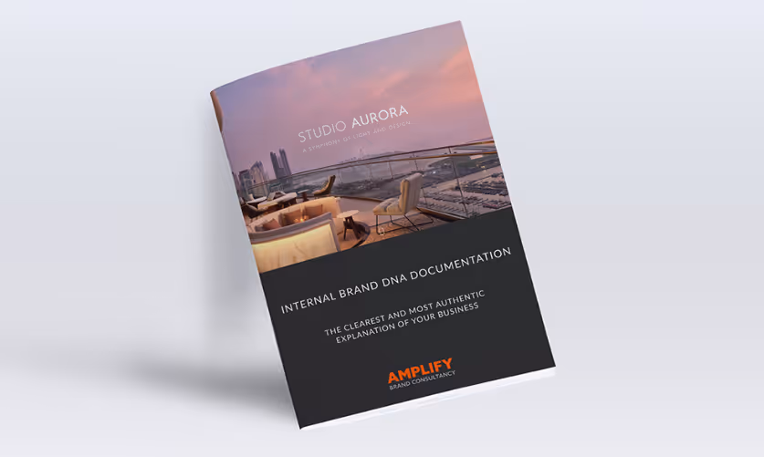 Brochure titled 'Studio Aurora' with a rooftop lounge at sunset and text about internal brand DNA documentation by Amplify Brand Consultancy.