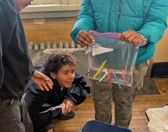 Students examine a sealed bag STEM project during class activity
