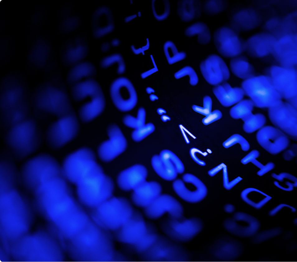 Close-up of glowing blue programming code characters on a dark screen.