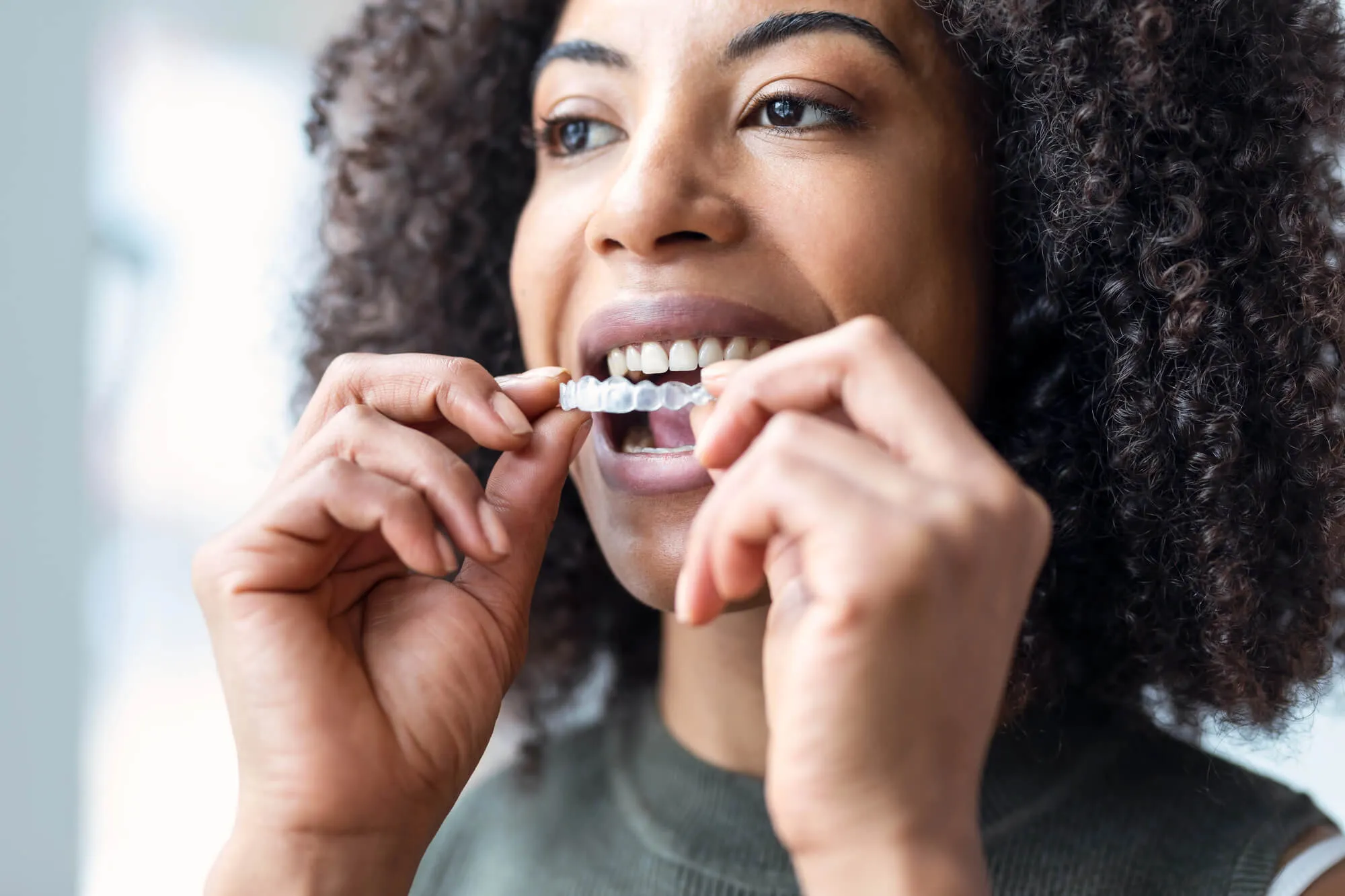 woman wearing a new set of invisalign in blue bell