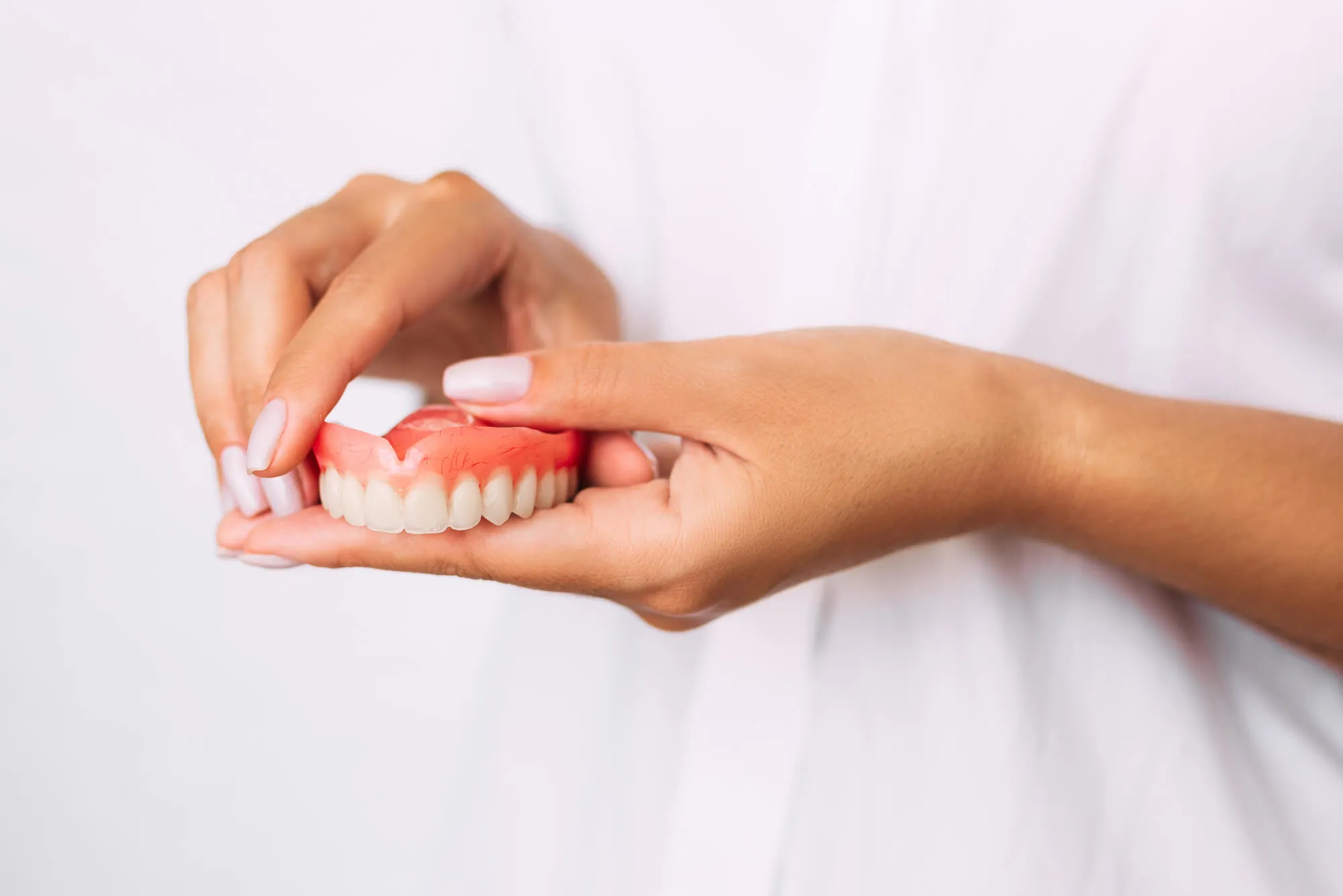 dentist holding Dentures blue bell pa