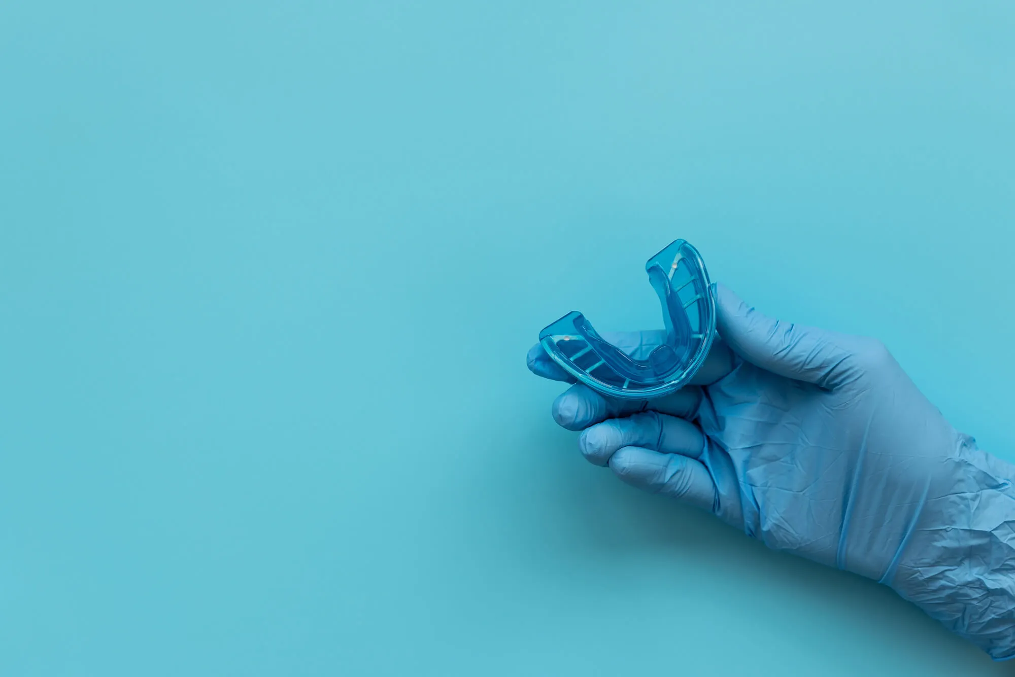 dentist holding a Night guards blue bell