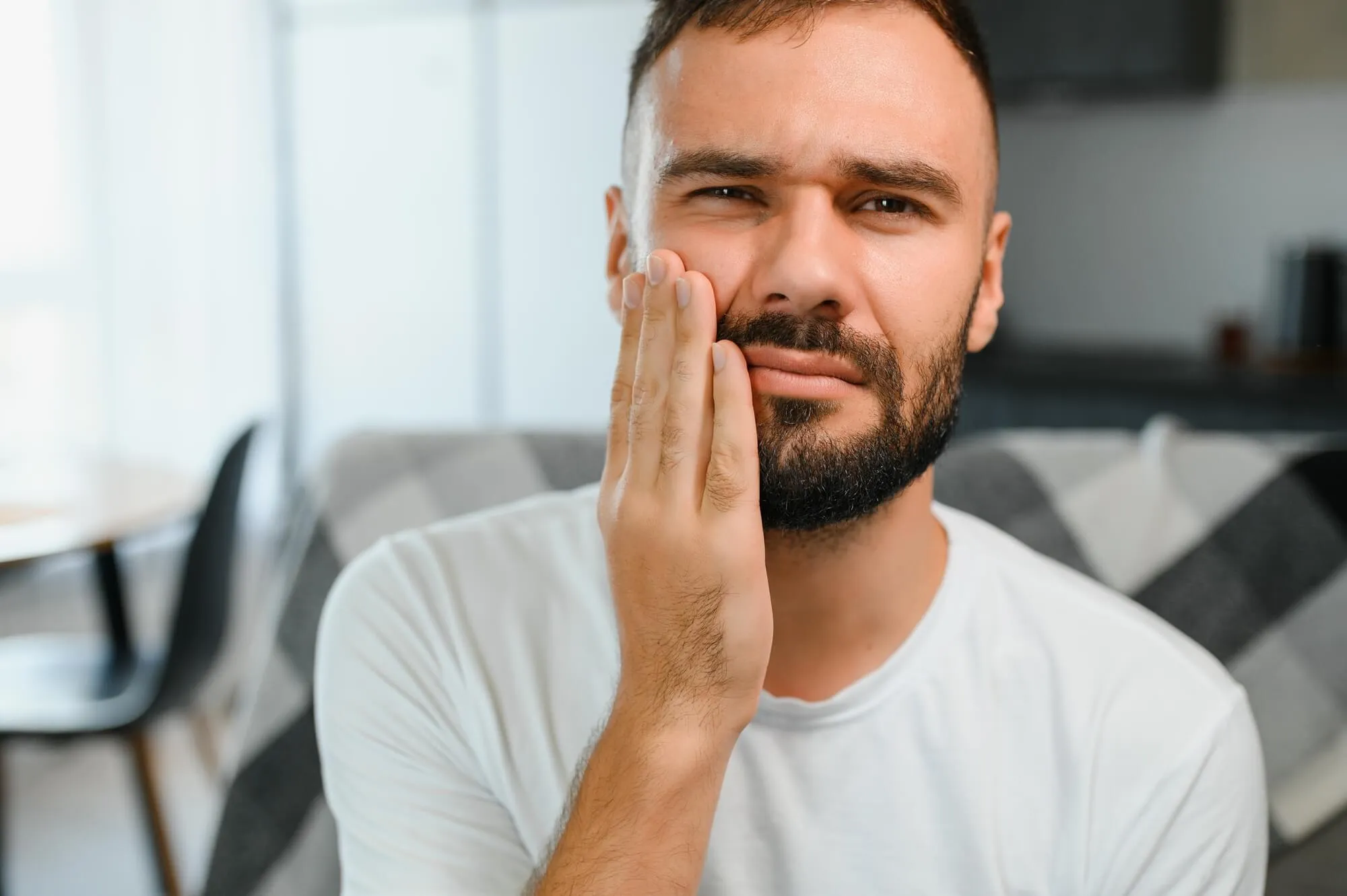 man in pain needs to see an emergency dentist blue bell